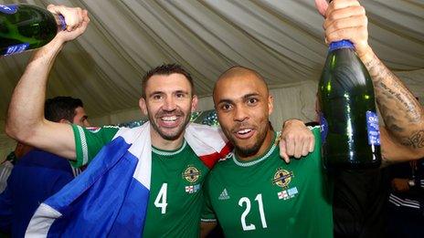Gareth McAuley and Josh Magennis celebrate after sealing Euro 2016 qualification