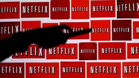Netflix logos with hand