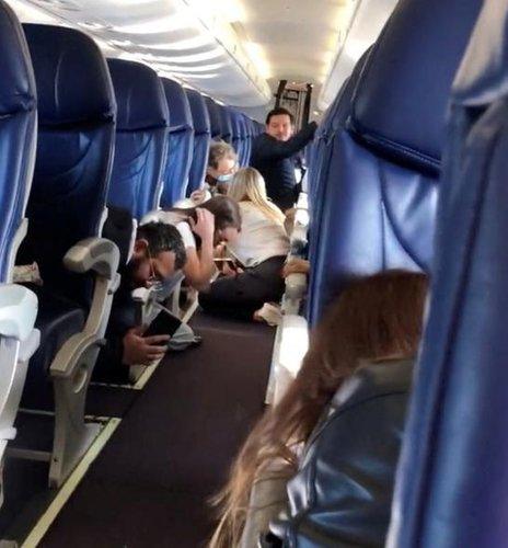 A grab from a video on social media appears to show passengers taking cover in their seats on a grounded plane, the Aeromexico 165 Culiacan, Sinaloa-Mexico City flight