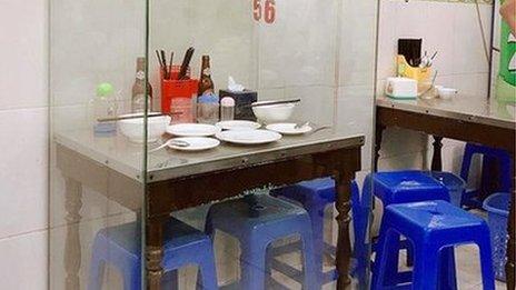 The table where Anthony Bourdain and Barack Obama had their famous meal in Hanoi has been put in a glass case for posterity