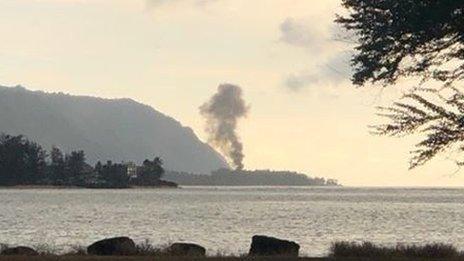 A plume of smoke rises after an airplane crash, seen from Kaiaka Bay Beach Park, in Haleiwa, Hawaii, U.S., June 21, 2019 in this image obtained from social media.