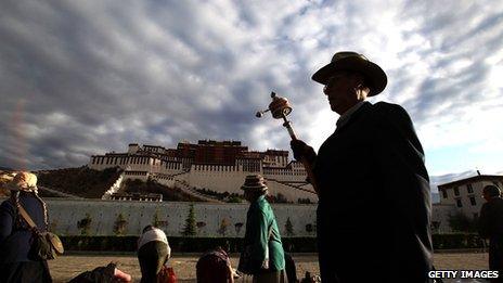 Pilgrims prostrate themselves in front of the Potala palace in Lhasa