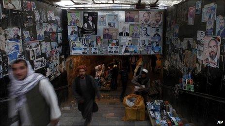 Afghans walk past election posters at a subway in Kabul, Afghanistan, on 23 August, 2010