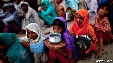 Pakistanis queue for food in a flood relief camp near Muzaffargarh in Punjab, Pakistan, on 25 August, 2010