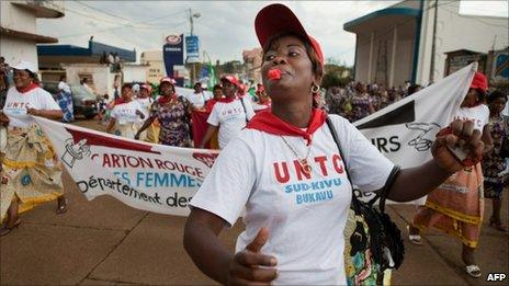 A Congolese woman blows a whistle during the "World March of Women" in Bukavu (17 October 2010)