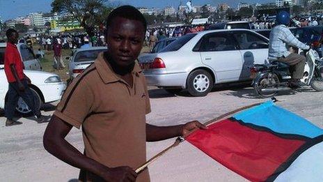 18-year old Moshi holding a flag at a campaign rally