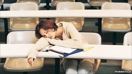 Female student asleep in lecture theatre