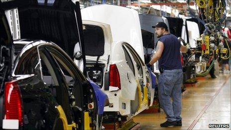 A General Motors assembly worker works on the production line for the 2011 Cadillac at the Grand River Assembly plant in Lansing, Michigan
