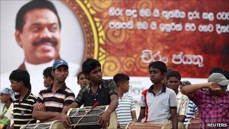 Boys with drums wait to take part in a dress rehearsal for President Mahinda Rajapaksa's second term swearing in ceremony at the presidential secretariat building in Colombo 17 November, 2010.