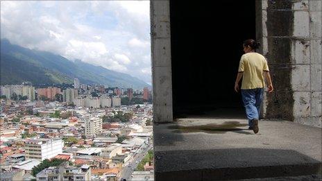 Person walks high in the Confinanza Tower in Caracas