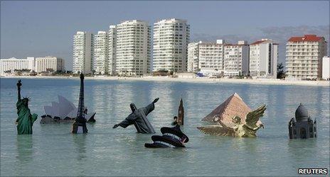Models of world landmarks in the sea off Cancun placed there by demonstrators