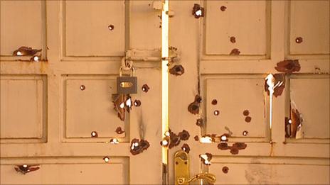 Bullet holes at the doors to Baghdad's Catholic cathedral
