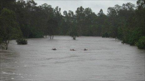 Three teenagers float down the Bremer river on air mattresses on 27 December 2010 (Image: Courtesy of Queensland Police)