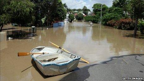 A boat is seen in a flooded street in a Brisbane suburb