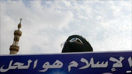 Muslim Brotherhood supporter holds a banner saying: "Islam is the solution" (2005)