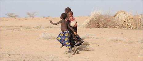 Young Turkana children heading towards road to look for water
