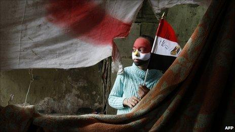 A young protester holds an Egyptian flag in Tahrir Square (7 February 2011)