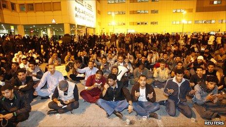 Protesters pray for injured comrades outside Salmaniya hospital, Manama, late on 17 February