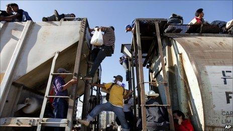 Central American migrants ride a northern bound train during their journey toward the US-Mexico border in Arriaga, in the state of Chiapas, southern Mexico, 3 February 2011