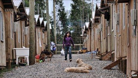A girl walks on 9 February 2011 amid basic houses in the coastal city of Dichato, 450 km south of Santiago, devastated by the quake and tsunami of 27 February 2010.