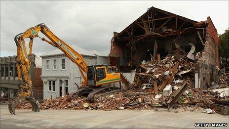 An earth mover is parked in a street to demolish a collapsed building in Lyttelton on 26 February 2011 in Christchurch, New Zealand.