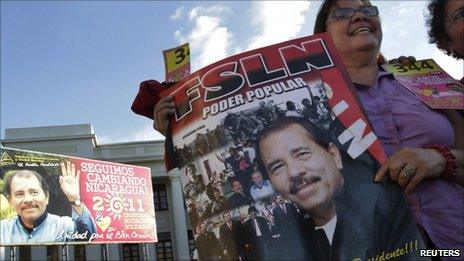 member of the Sandinista Party holds a poster with an image of Nicaragua President Daniel Ortega during the Sandinista Congress at Revolution Square in Managua 26 February, 2011