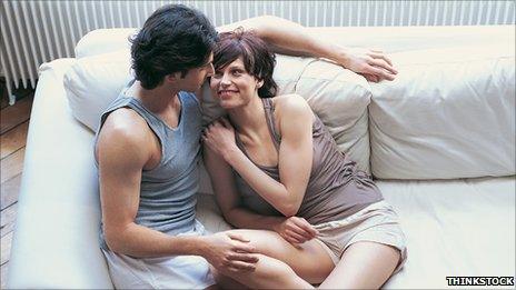 Couple in vest tops by a radiator