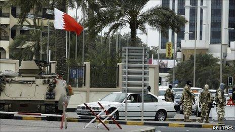 GCC troops guard an entrance to Salmaniya Hospital in Manama, 18 March