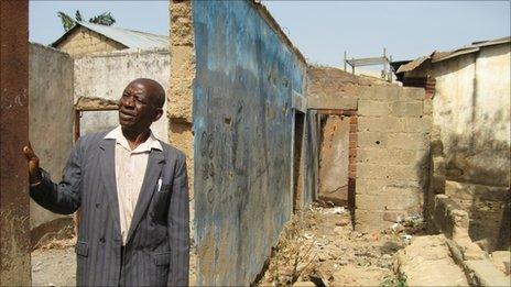 Reverend Noah Maikano in the ruins of his home