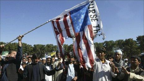 Afghans burn an American flag during a protest in Herat province