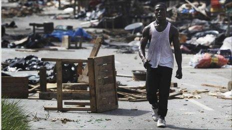 A man walks through a ransacked market in Abidjan April 14, 2011