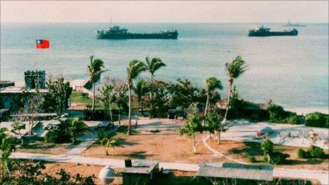 File photo shows two Taiwanese warships docking near Taiping Island, one of the disputed Spratly Island chain, with the Taiping military base in the foreground