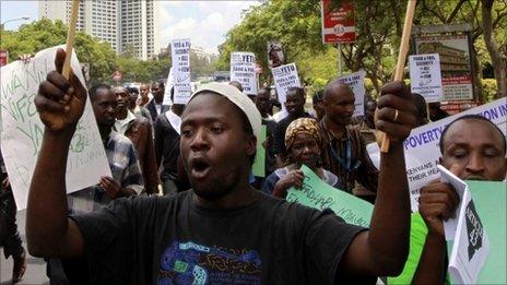 Kenyan protesters hold placards during a demonstration against food and fuel prices rises in Nairobi, Kenya