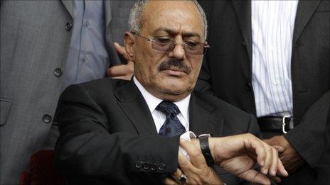 Yemeni President Ali Abdullah Saleh consults his watch at a rally in the capital Sanaa, 15 April