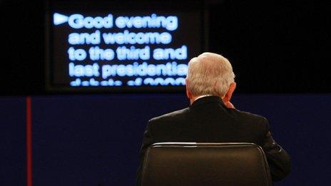 A man sitting in front of a teleprompter