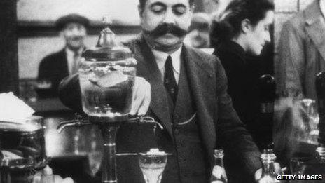 25th March 1939: A French publican in London, Victor Berlemont, preparing a drink of absinthe
