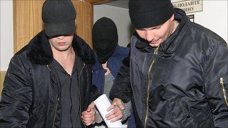 Yevgenia Khasis, centre, is led into court. Nov 2009