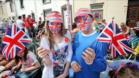 Jemma Denners, 14, and Jay Roger, 11, with union jack face paint and flags at a street party in Fleet Street, Sandfields, Swansea