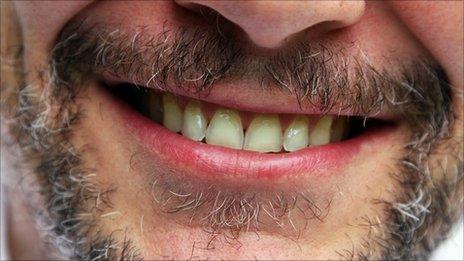 Smiling man showing teeth
