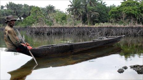 A man paddling a canoe in Rivers state, Nigeria