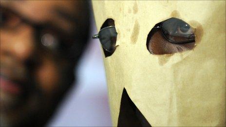 A gay Ugandan man seeking asylum hides his face in 2010