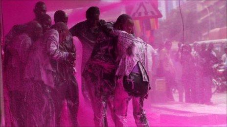 Police spray Ugandan opposition party leaders with pink liquid in the capital Kampala