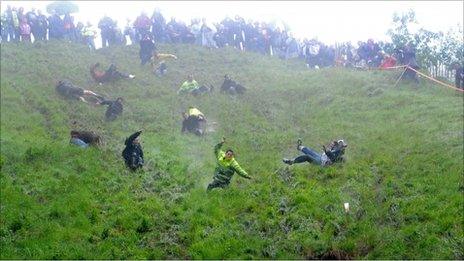 Competitors take part in the unofficial cheese rolling event on Coppers Hill
