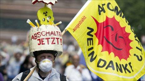 A demonstrator carries a flag reading "nuclear power? no thank you!" during a protest in Berlin, Germany, 28 May 2011