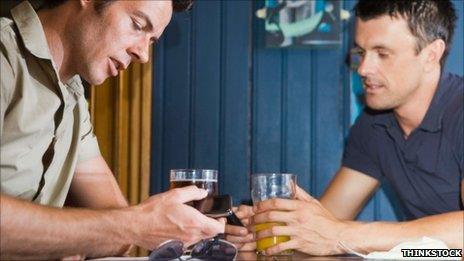 Man using smartphone in pub