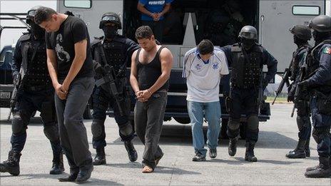 Members of Mexican drug cartel "La Familia Michoacana" escorted by police