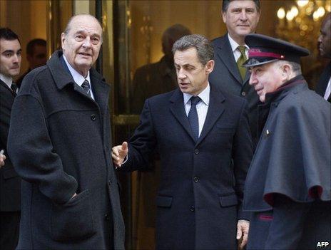 Former French President Jacques Chirac and his successor Nicolas Sarkozy emerge from a Paris restaurant, 21 January 2011