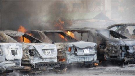 Burning vehicles in police HQ car park