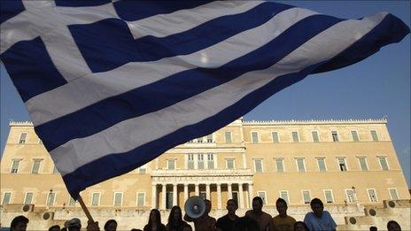 Protesters wave a Greek flag in Athens (17 June 2011)
