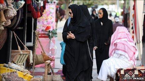 Saudi Women walk through a market